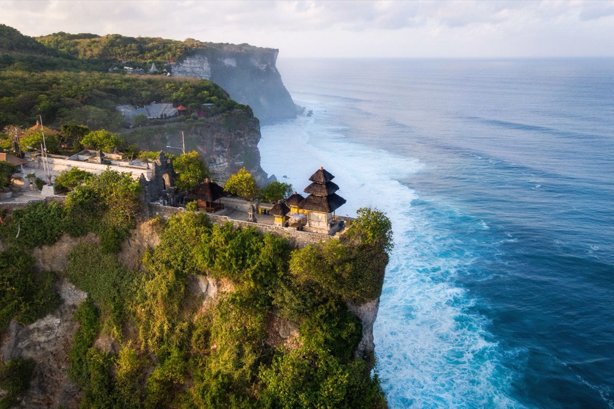 Aerial view of the Uluwatu coastline on Bali's Bukit peninsula, with clifftop villas above the surf